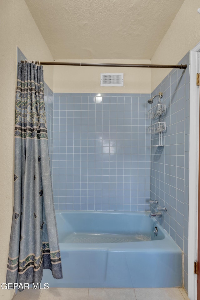 2312 Grant Ave, El Paso, TX 79930 - bathroom with shower / bathtub combination with curtain, tile patterned flooring, and a textured ceiling