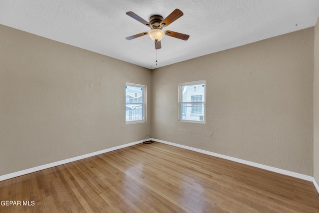 2312 Grant Ave, El Paso, TX 79930 - unfurnished room featuring light wood-style flooring, baseboards, ceiling fan, and a textured ceiling