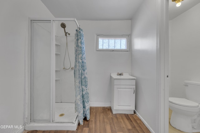 2312 Grant Ave, El Paso, TX 79930 - full bathroom with a shower stall, wood finished floors, toilet, and a sink