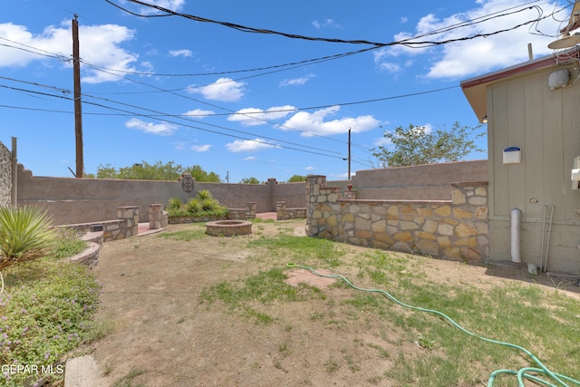 2312 Grant Ave, El Paso, TX 79930 - fenced backyard featuring a fire pit