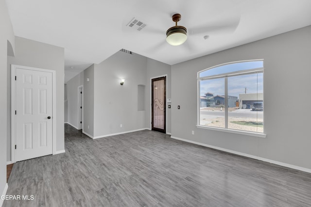 14378 N Cave Dr, El Paso, TX 79938 - unfurnished living room featuring a ceiling fan, wood finished floors, baseboards, and arched walkways