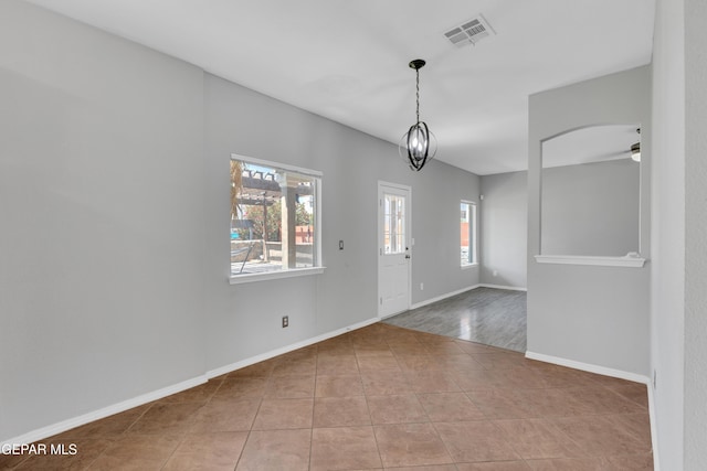 14378 N Cave Dr, El Paso, TX 79938 - empty room with ceiling fan, tile patterned flooring, baseboards, and arched walkways