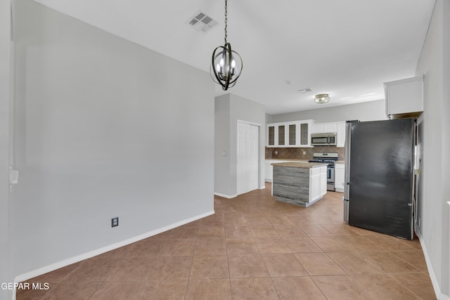 14378 N Cave Dr, El Paso, TX 79938 - kitchen featuring appliances with stainless steel finishes, decorative backsplash, white cabinets, baseboards, and light countertops