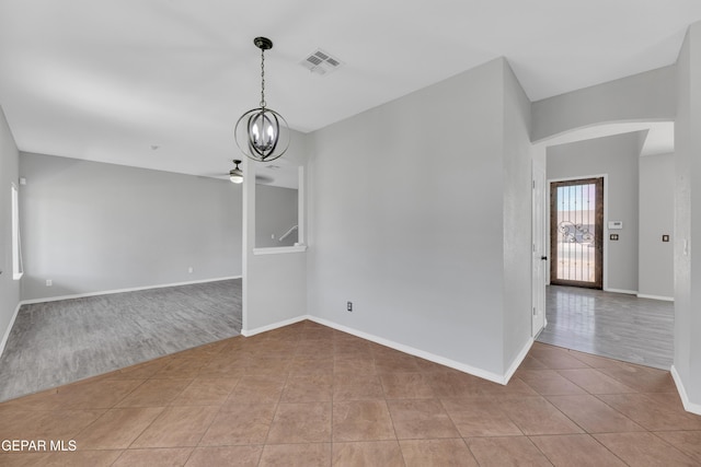 14378 N Cave Dr, El Paso, TX 79938 - unfurnished room featuring light tile patterned floors, ceiling fan, a chandelier, and baseboards