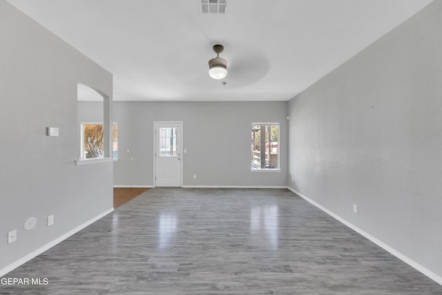 14378 N Cave Dr, El Paso, TX 79938 - unfurnished living room featuring ceiling fan, wood finished floors, baseboards, and arched walkways