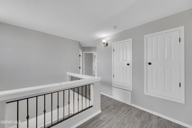 14378 N Cave Dr, El Paso, TX 79938 - hall with wood finished floors, baseboards, and an upstairs landing
