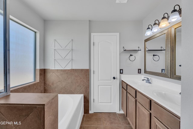 14378 N Cave Dr, El Paso, TX 79938 - bathroom featuring double vanity, a garden tub, tile patterned floors, and tile walls