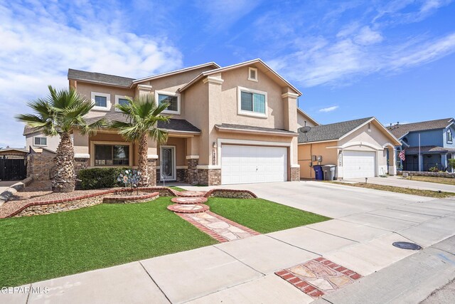 12800 Tierra Alexis Dr, El Paso, TX 79938 - view of front of house featuring stucco siding, stone siding, concrete driveway, a front yard, and a garage