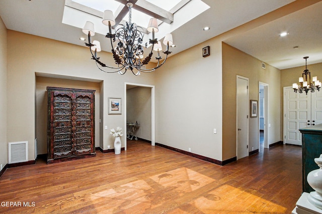 6006 Balcones Ct Unit 19, El Paso, TX 79912 - dining space with a chandelier, a skylight, wood finished floors, baseboards, and recessed lighting