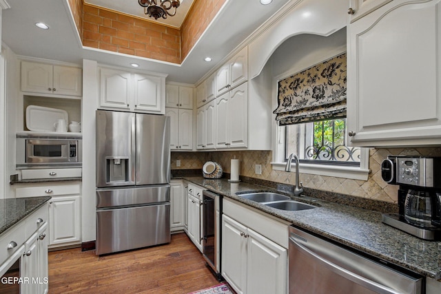 6006 Balcones Ct Unit 19, El Paso, TX 79912 - kitchen featuring stainless steel appliances, a raised ceiling, a sink, white cabinets, and dark wood finished floors