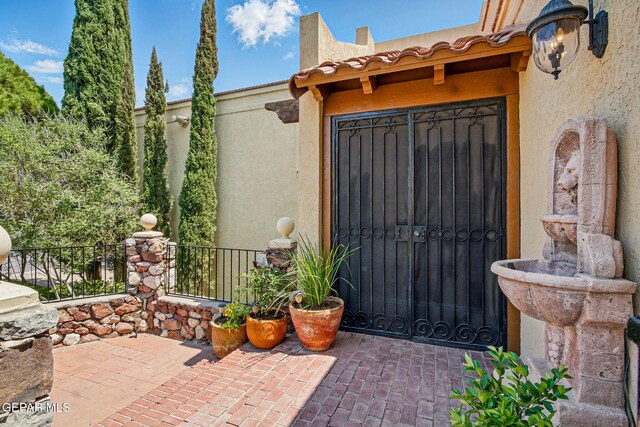 6006 Balcones Ct Unit 19, El Paso, TX 79912 - property entrance with stucco siding and a patio
