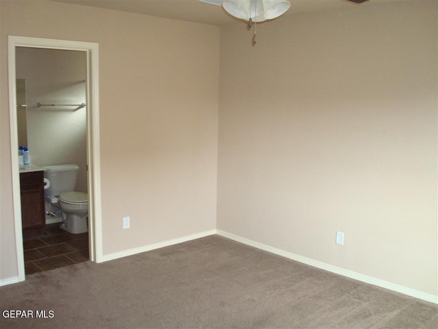 12036 Copper Hill Pl, El Paso, TX 79934 - unfurnished bedroom with carpet flooring, baseboards, and connected bathroom