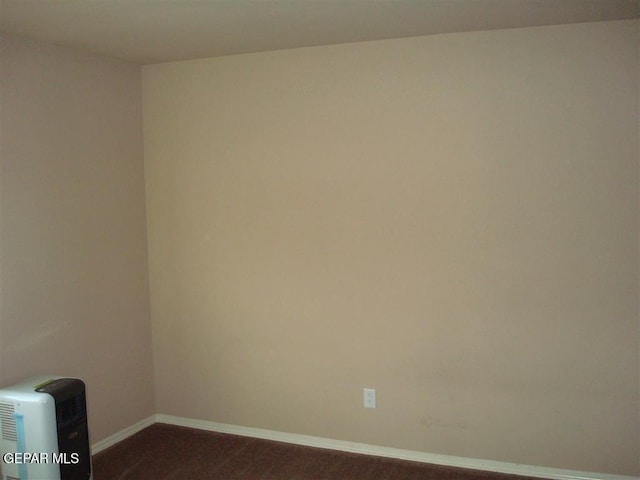 12036 Copper Hill Pl, El Paso, TX 79934 - empty room featuring baseboards and dark wood-type flooring