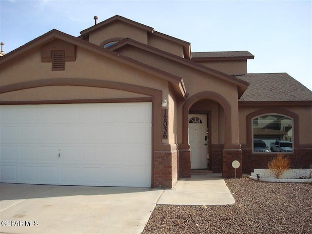 12036 Copper Hill Pl, El Paso, TX 79934 - mediterranean / spanish-style house with a garage, driveway, roof with shingles, and stucco siding