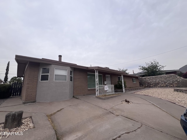 318 Olivia Cir, El Paso, TX 79912 - rear view of property featuring brick siding and a porch