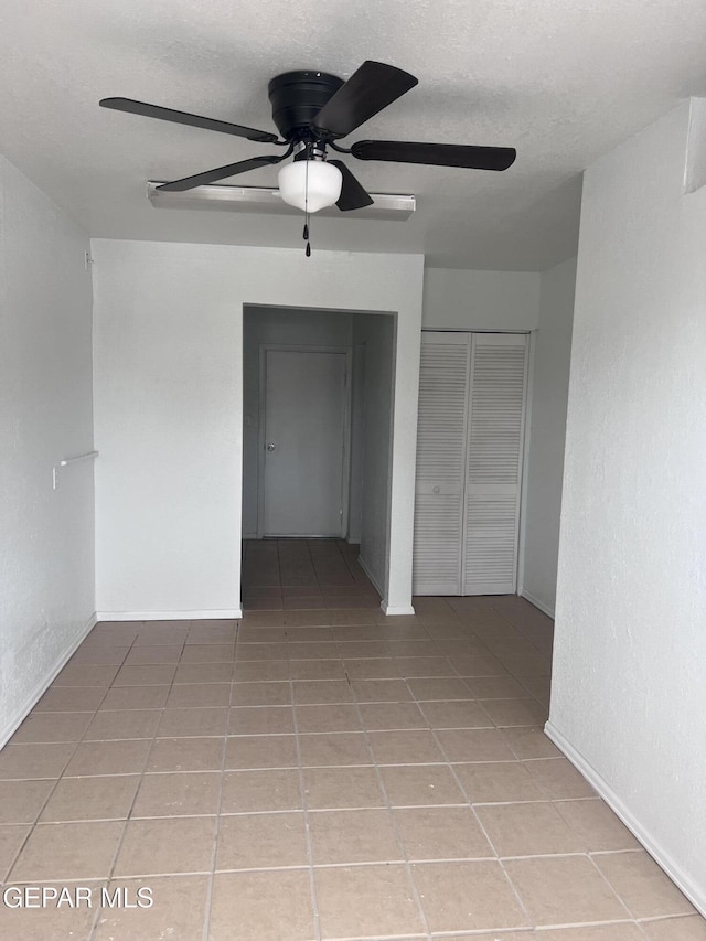 318 Olivia Cir, El Paso, TX 79912 - unfurnished bedroom featuring tile patterned flooring, a closet, baseboards, and ceiling fan