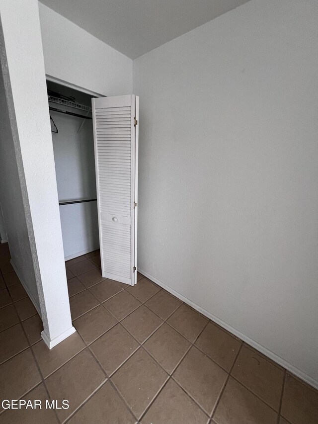 318 Olivia Cir, El Paso, TX 79912 - unfurnished bedroom featuring tile patterned floors, a closet, and baseboards