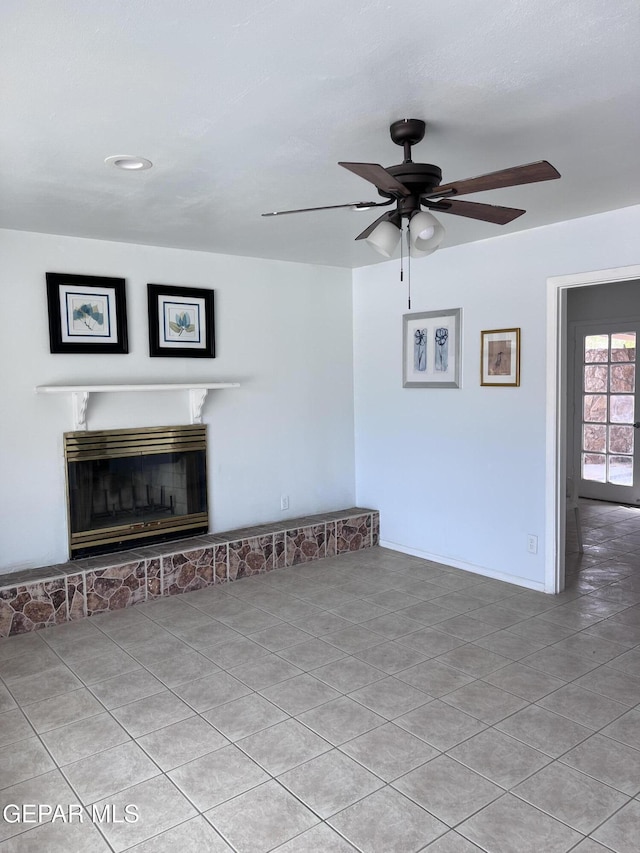 318 Olivia Cir, El Paso, TX 79912 - unfurnished living room with ceiling fan, a fireplace with raised hearth, tile patterned flooring, and recessed lighting