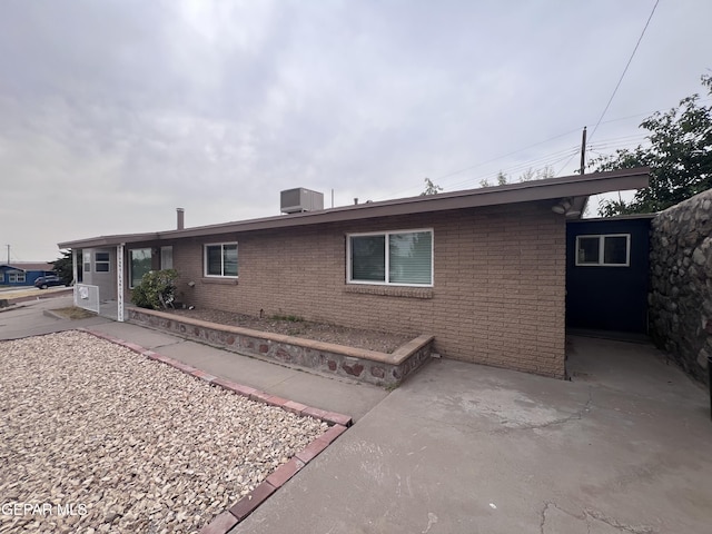 318 Olivia Cir, El Paso, TX 79912 - view of front of property with brick siding, a patio, and central air condition unit