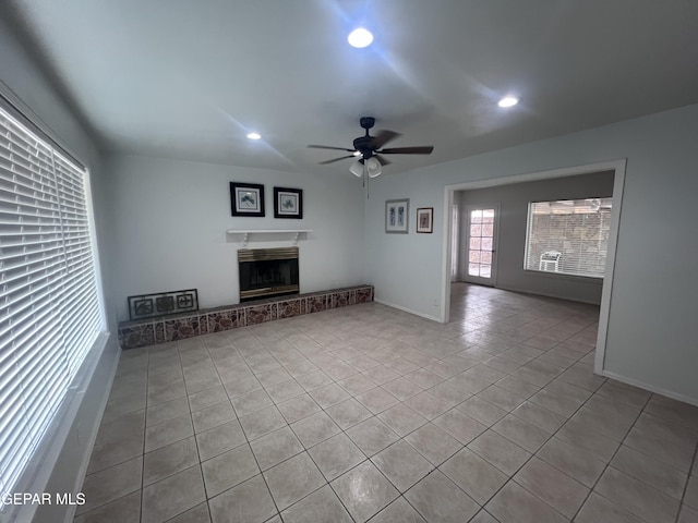 318 Olivia Cir, El Paso, TX 79912 - unfurnished living room with ceiling fan, tile patterned flooring, recessed lighting, a fireplace with raised hearth, and baseboards