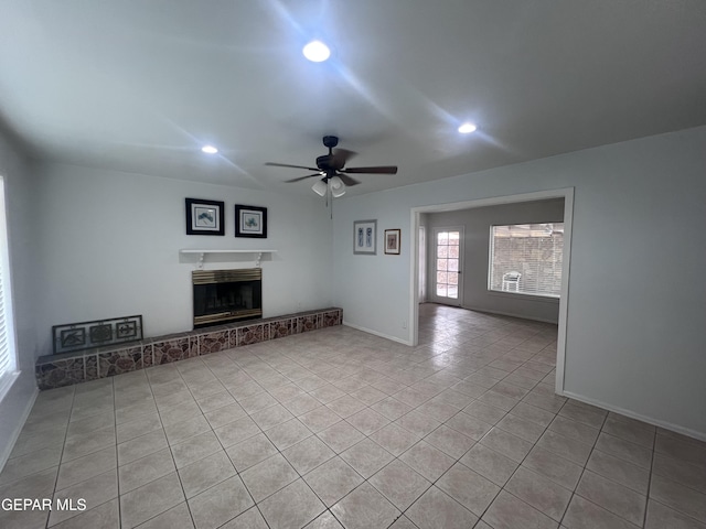318 Olivia Cir, El Paso, TX 79912 - unfurnished living room with light tile patterned floors, ceiling fan, recessed lighting, a fireplace with raised hearth, and baseboards