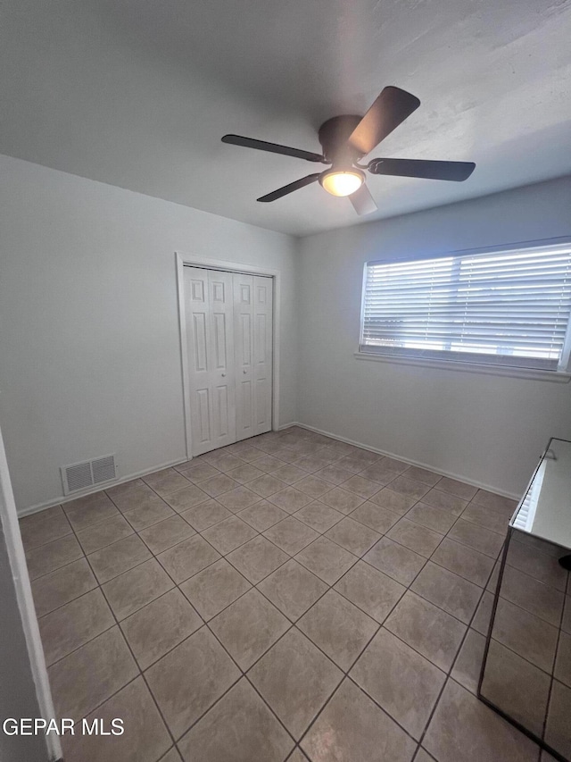 318 Olivia Cir, El Paso, TX 79912 - unfurnished bedroom with tile patterned flooring, a closet, ceiling fan, and baseboards