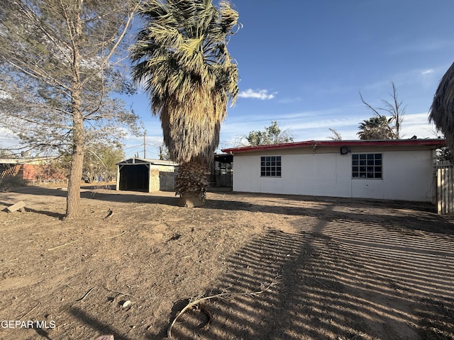 10385 Potencia Dr, Socorro, TX 79927 - back of house featuring an outdoor structure and stucco siding