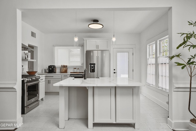 3100 Wheeling Ave, El Paso, TX 79930 - kitchen with stainless steel appliances, range hood, pendant lighting, a kitchen island, and white cabinetry