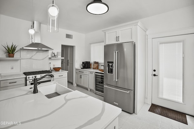 3100 Wheeling Ave, El Paso, TX 79930 - kitchen with stainless steel appliances, wall chimney exhaust hood, wine cooler, open shelves, and a sink