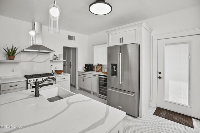 3100 Wheeling Ave, El Paso, TX 79930 - kitchen featuring stainless steel appliances, wall chimney range hood, wine cooler, open shelves, and a sink