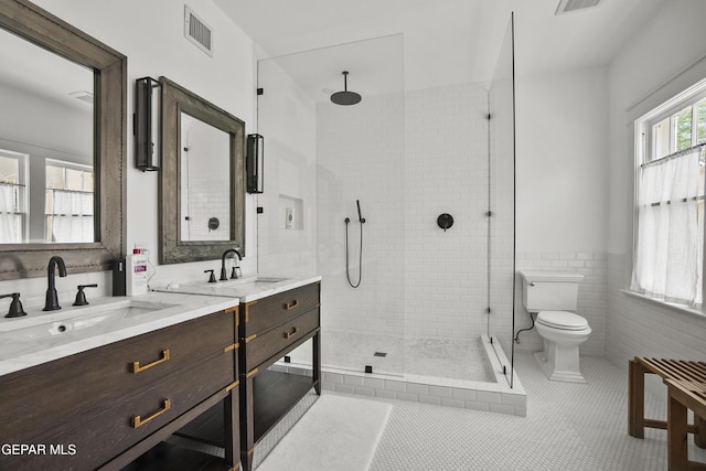 3100 Wheeling Ave, El Paso, TX 79930 - full bathroom featuring double vanity, toilet, a stall shower, and tile walls