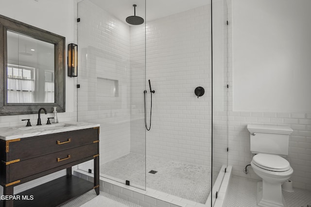 3100 Wheeling Ave, El Paso, TX 79930 - bathroom with tile walls, a shower stall, vanity, toilet, and tile patterned floors
