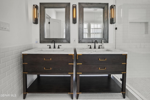 3100 Wheeling Ave, El Paso, TX 79930 - full bathroom featuring double vanity, tile walls, and a wainscoted wall