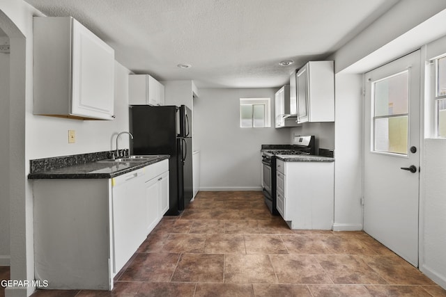 3100 Wheeling Ave, El Paso, TX 79930 - kitchen featuring gas range, a sink, dark countertops, dishwashing machine, and white cabinets