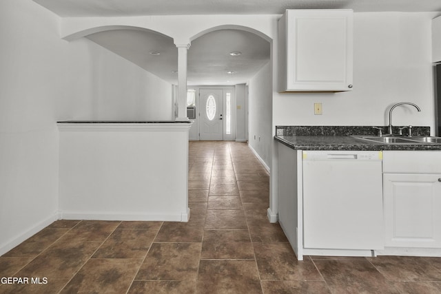 3100 Wheeling Ave, El Paso, TX 79930 - kitchen with white dishwasher, a sink, dark countertops, white cabinets, and baseboards