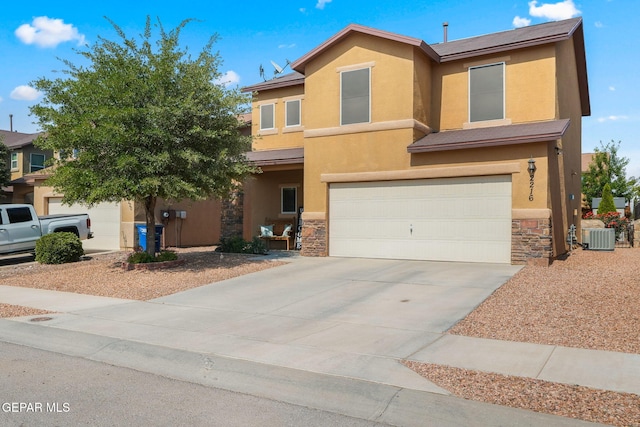 2216 Azure Point Ave, El Paso, TX 79938 - view of front facade featuring central AC, an attached garage, stucco siding, stone siding, and driveway