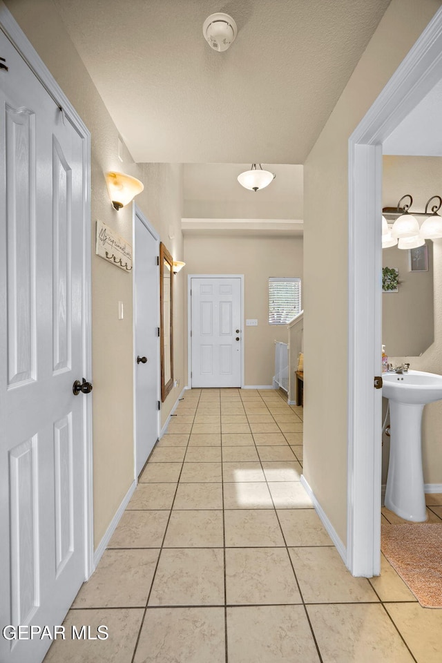 2216 Azure Point Ave, El Paso, TX 79938 - hallway featuring light tile patterned flooring and baseboards