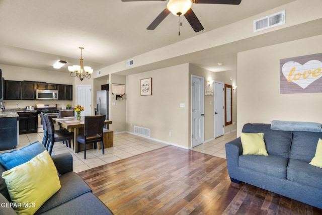 2216 Azure Point Ave, El Paso, TX 79938 - living area featuring a chandelier, light wood-style flooring, ceiling fan, and baseboards
