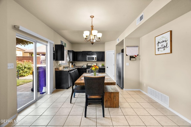 2216 Azure Point Ave, El Paso, TX 79938 - dining space featuring a chandelier, light tile patterned flooring, and baseboards