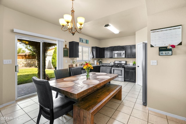 2216 Azure Point Ave, El Paso, TX 79938 - dining space with a chandelier, light tile patterned floors, and baseboards