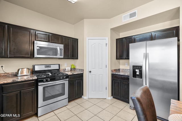 2216 Azure Point Ave, El Paso, TX 79938 - kitchen featuring appliances with stainless steel finishes, light tile patterned flooring, and dark brown cabinets