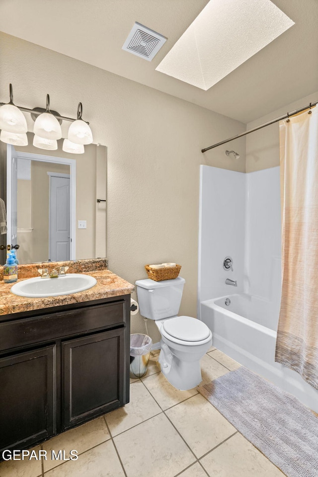 2216 Azure Point Ave, El Paso, TX 79938 - full bath with toilet, shower / tub combo, a skylight, vanity, and tile patterned flooring