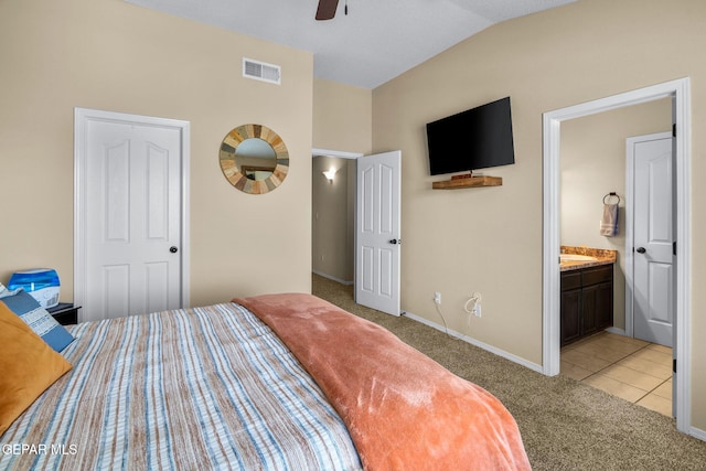 2216 Azure Point Ave, El Paso, TX 79938 - bedroom with light carpet, lofted ceiling, baseboards, light tile patterned flooring, and ensuite bathroom