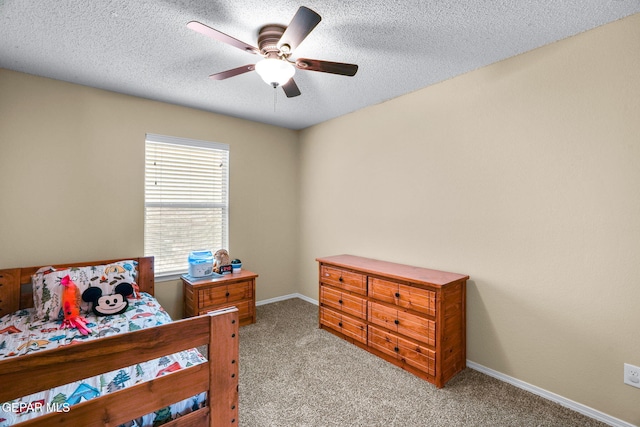 2216 Azure Point Ave, El Paso, TX 79938 - carpeted bedroom with baseboards, a textured ceiling, and a ceiling fan