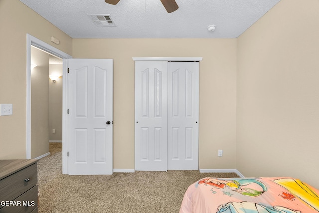 2216 Azure Point Ave, El Paso, TX 79938 - carpeted bedroom with a closet, baseboards, a textured ceiling, and a ceiling fan