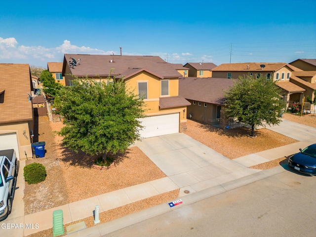 2216 Azure Point Ave, El Paso, TX 79938 - view of front facade with stucco siding, a residential view, concrete driveway, and a garage