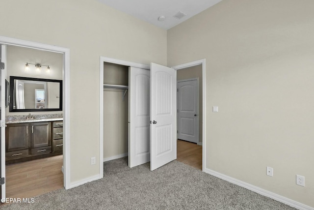 3916 Aspiration, El Paso, TX 79938 - unfurnished bedroom featuring light colored carpet, a closet, baseboards, and ensuite bath