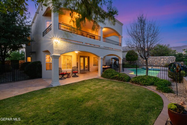 6308 Franklin Vis, El Paso, TX 79912 - rear view of house with a balcony, stucco siding, a patio area, and french doors