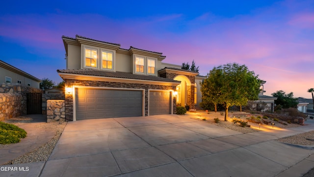 6308 Franklin Vis, El Paso, TX 79912 - view of front facade featuring stone siding, a tile roof, driveway, a garage, and a gate