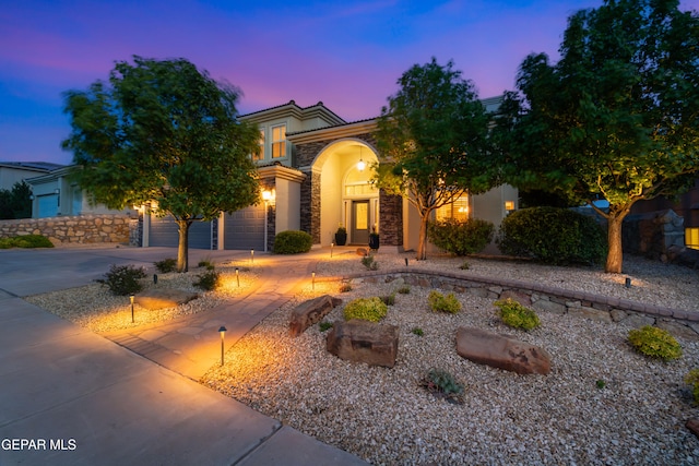 6308 Franklin Vis, El Paso, TX 79912 - view of front of property featuring stone siding, driveway, a tile roof, and stucco siding